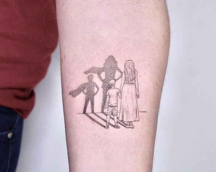 3D tattoo of a child and woman with superhero shadows, showcasing tattoo artists' creativity.