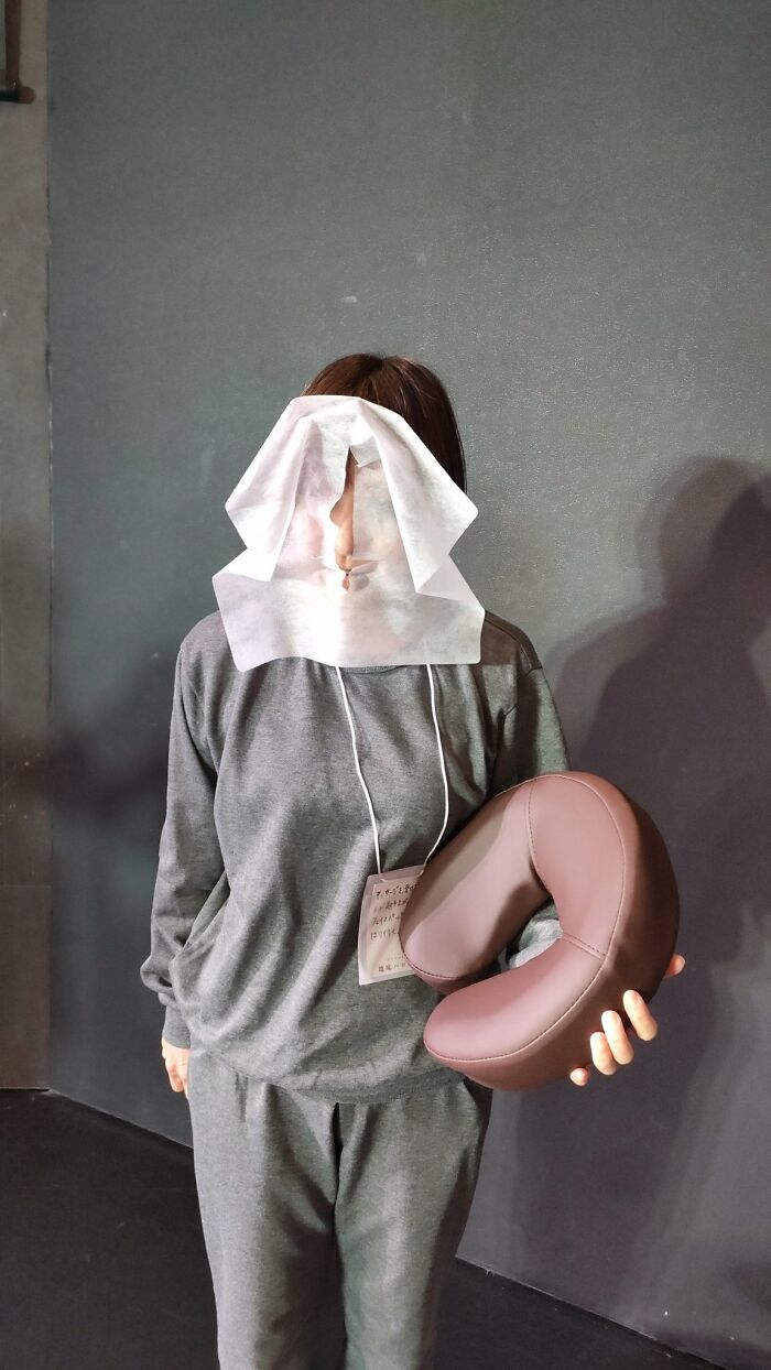 A Person Who Stood Up With A Face Paper Sticking To Them After Getting A Massage