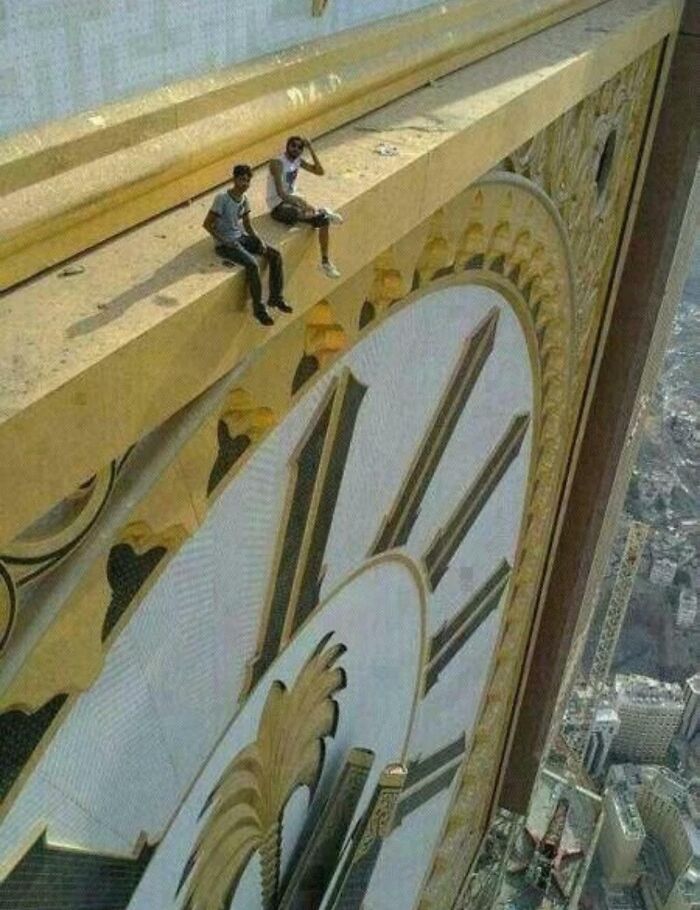 People Sat On The Abraj Al Bait Clock Tower In Mecca