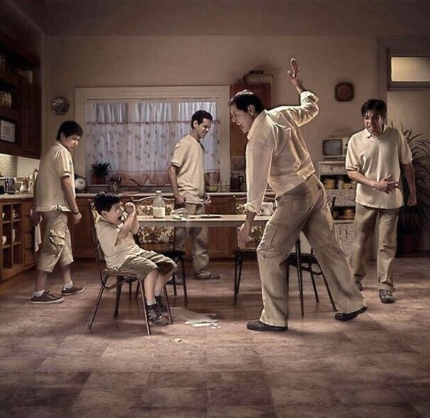 Man angrily raising hand to hit child in kitchen, highlighting issues pointed out in society through powerful imagery.