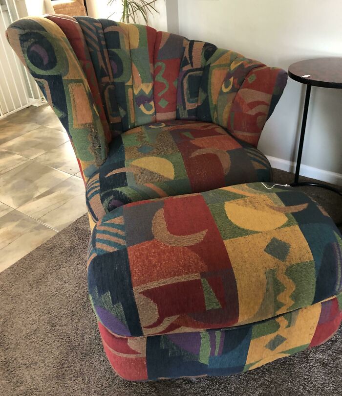 Colorful '90s patterned armchair in a cozy living room setting.