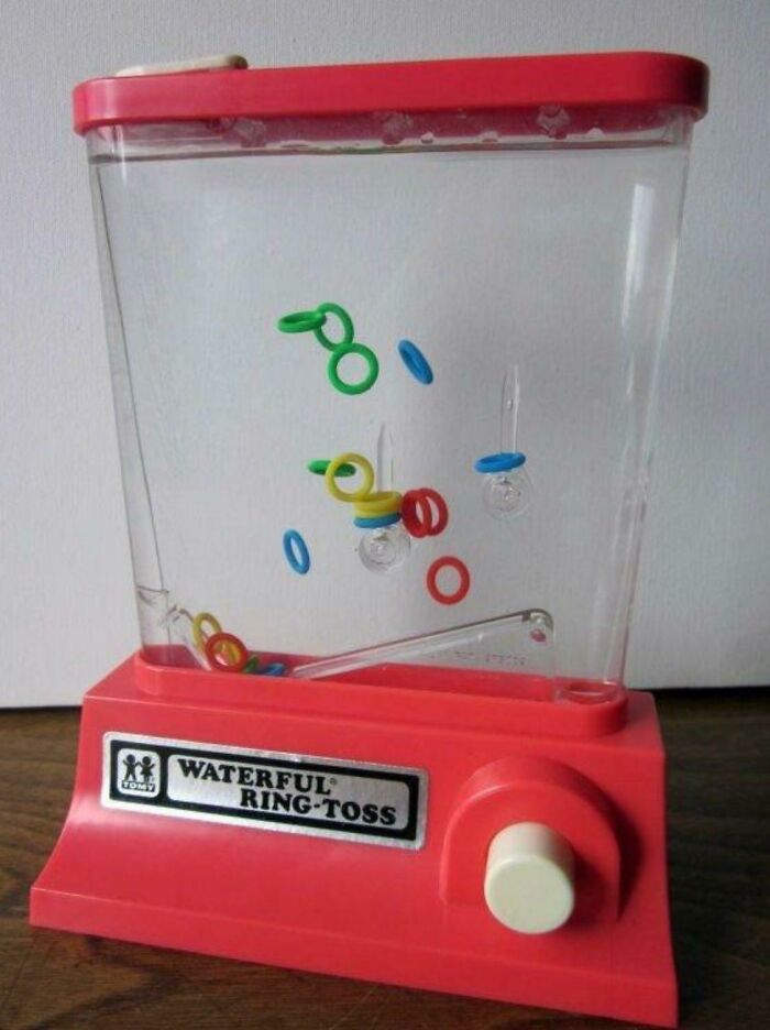 Vintage Waterful Ring-Toss game, showcasing colorful rings suspended, evoking nostalgia and humor about getting old.