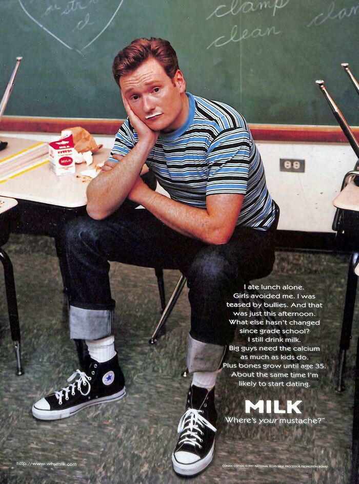 Vintage advertisements milk campaign featuring a young man with a milk mustache sitting in a classroom setting.