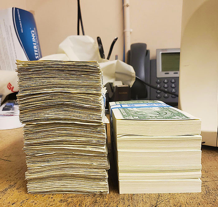 500 Circulated $1 Bills Next To 500 Un-Circulated $1 Bills