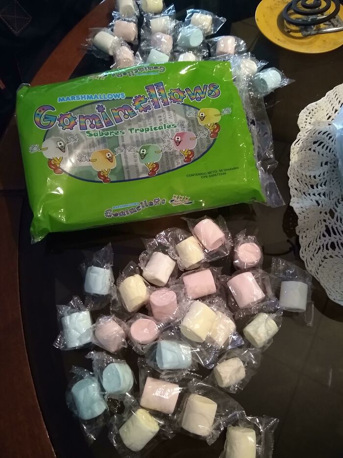 Individually wrapped marshmallows spilling from a large green bag showing a major packaging fail with confusing presentation.