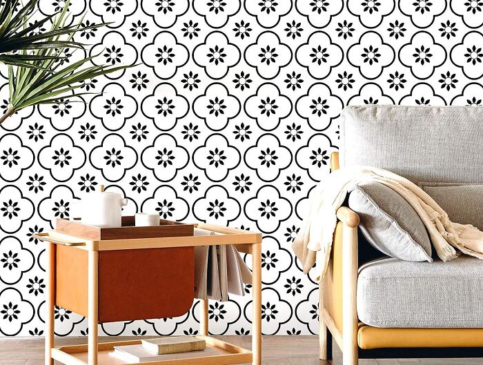 Room with Moroccan patterned wallpaper gray sofa and table