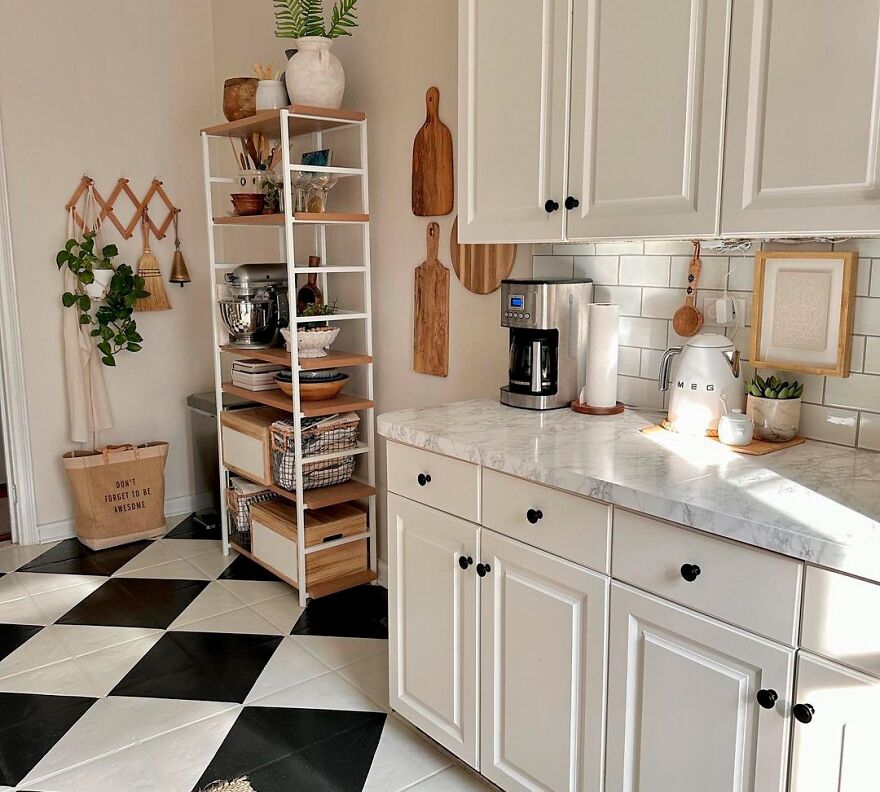 White kitchen cabinets with black and white floor tiles, wooden accents, and modern stylish kitchen cabinets design.