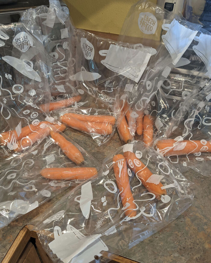 Individual carrots packed separately in multiple plastic bags, showcasing a facepalm-worthy packaging fail with excessive waste.