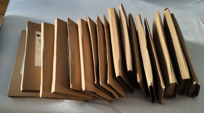 Stack of poorly packaged cardboard mailers with damaged edges, illustrating common facepalm-worthy packaging fails.