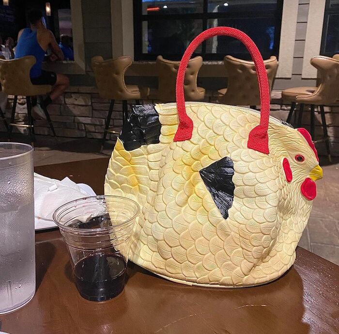 Quirky chicken-shaped handbag on a cafe table, ideal unconventional present for eccentric friends.