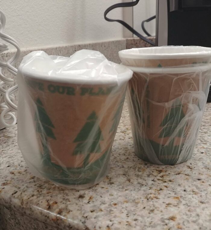 Two disposable cups wrapped in plastic bags on a countertop showing facepalm-worthy packaging fails with no reason to be bad.