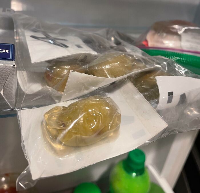 Poorly sealed plastic packaging containing liquid and solid items inside a refrigerator illustrating packaging fails.