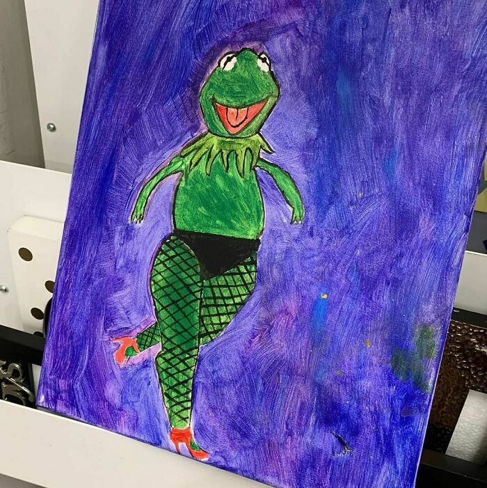 Colorful painting of a quirky Kermit character in fishnet tights and heels, one of the weird items donated to thrift stores.