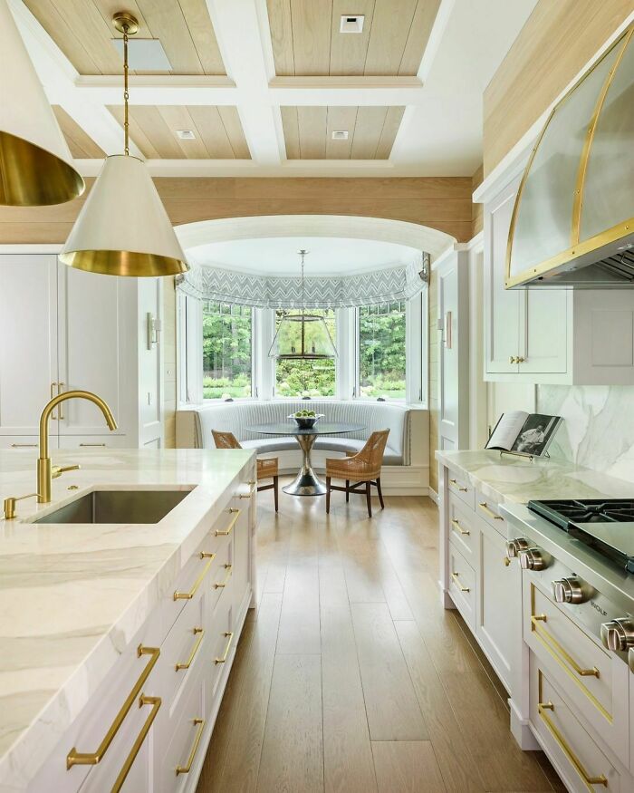 Bright kitchen featuring a cozy window seat with natural light and elegant decor for a relaxing nook.