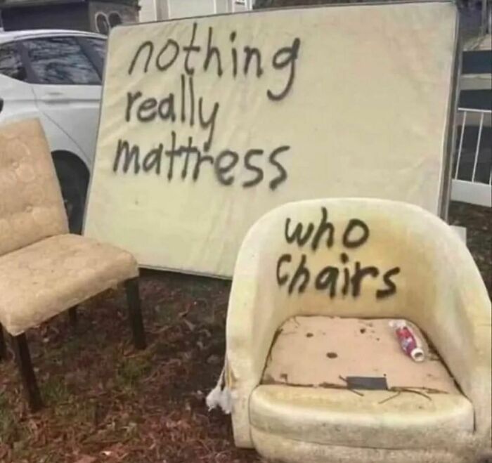 Old mattress and worn chair with graffiti text, showcasing a confusing and unsettling scene from I Would Prefer Not To pics.