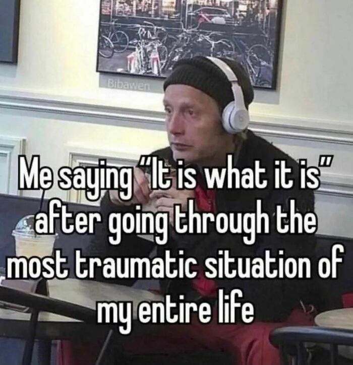 Man wearing headphones sitting in a cafe with a caption about coping after a traumatic experience, funny confusing pics theme.
