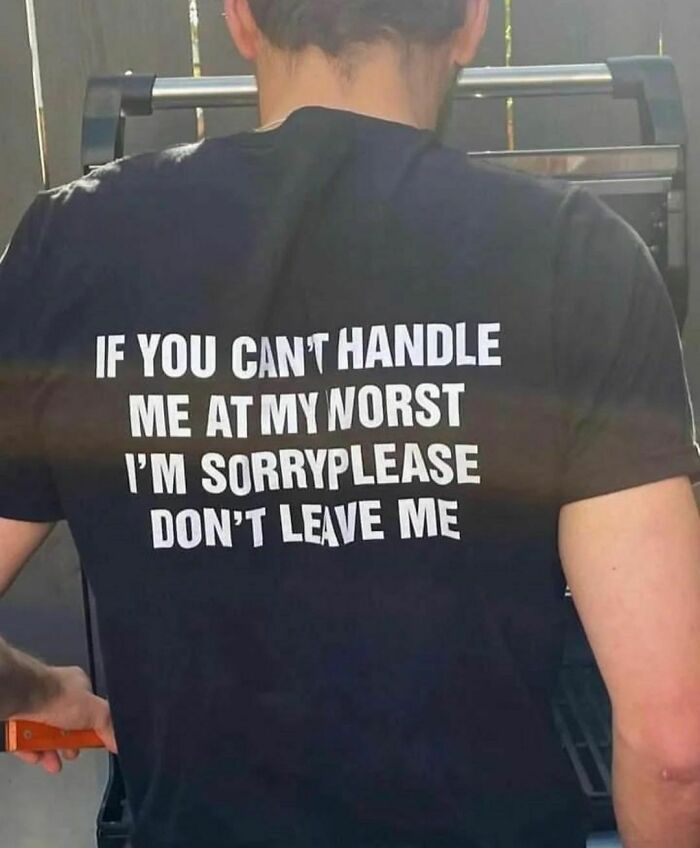 Person wearing a black shirt with confusing and unsettling text about handling worst moments, fitting hilarious pics theme.