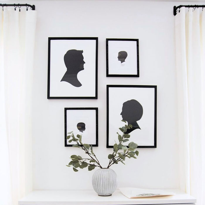 Framed silhouette pictures arranged on a white wall with minimalist decor for easy and creative wall art ideas.
