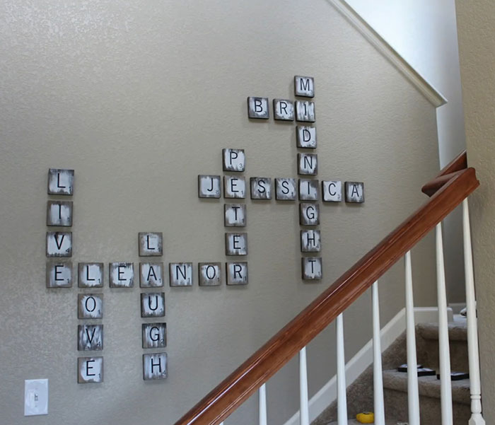 Scrabble tile wall art arranged near stairs, showcasing a creative and stylish space with easy wall art ideas.