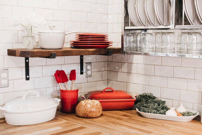 Brown wooden butcher block countertop with kitchenware, fresh bread, and herbs showcasing timeless durability and classic charm. Brown wooden butcher block countertop with kitchenware, fresh bread, and herbs showcasing timeless durability and classic charm.