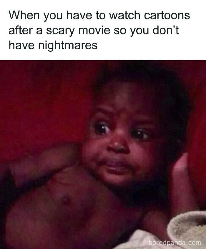 Baby with wide eyes looking concerned after watching a scary movie; relatable meme humor.