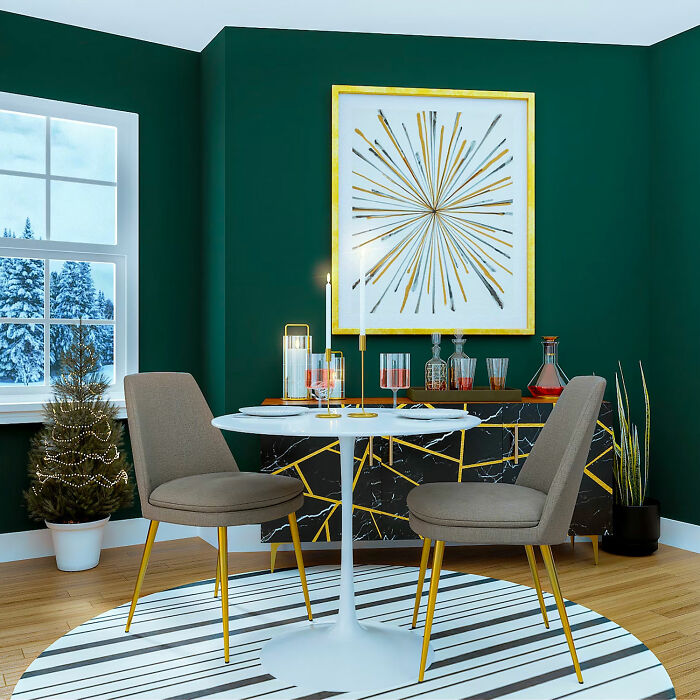 Green dining room with white table and gray chairs, decorated for family gatherings with stylish modern accents.