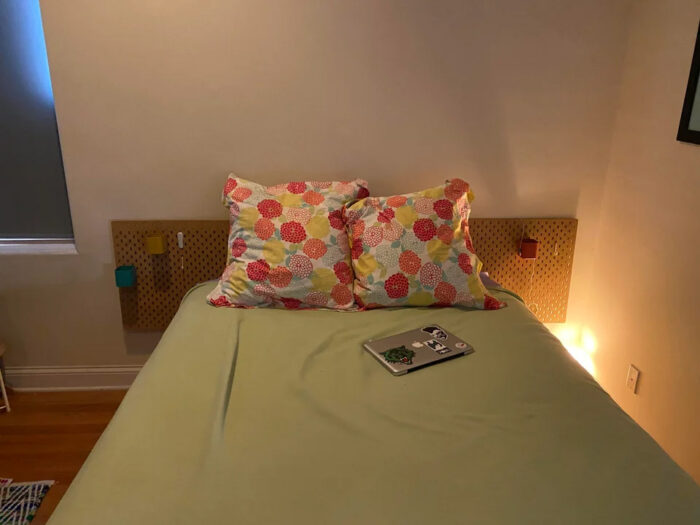 Two pillows and laptop on the bed