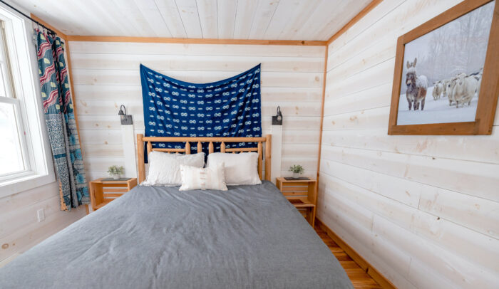 Big bed near the wall with a carpet