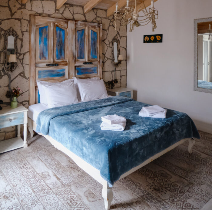 Big bed with headboard made of old doors