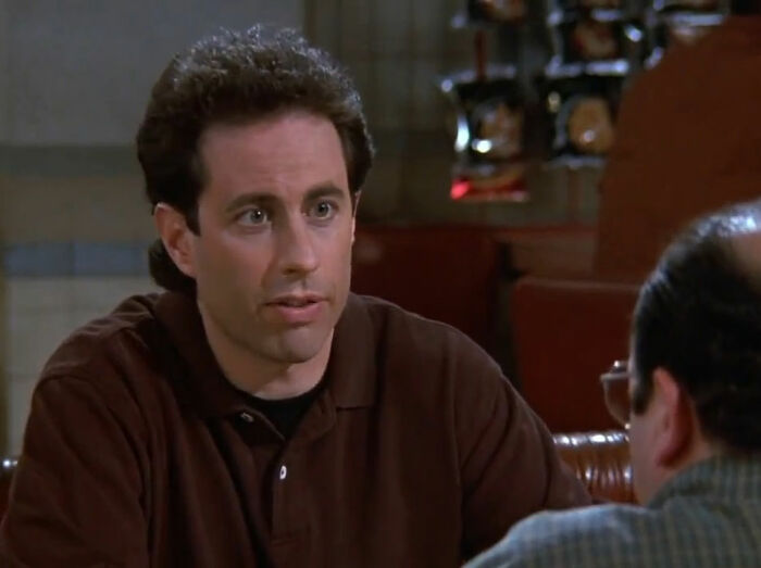 Jerry Seinfeld sitting and talking Seinfeld