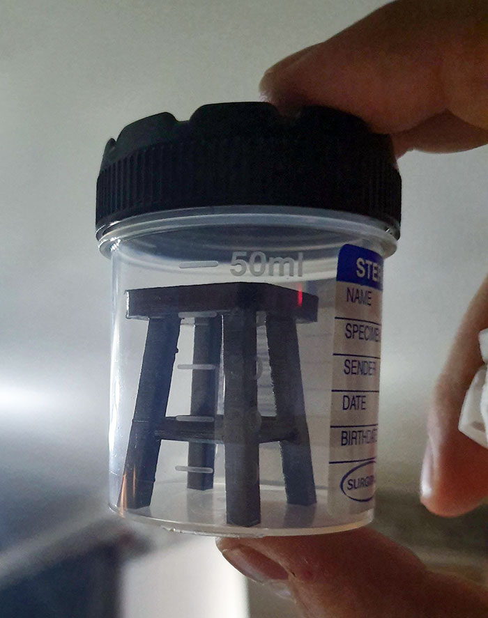 A mini stool inside a 50ml specimen jar, showcasing a parent's humorous touch.