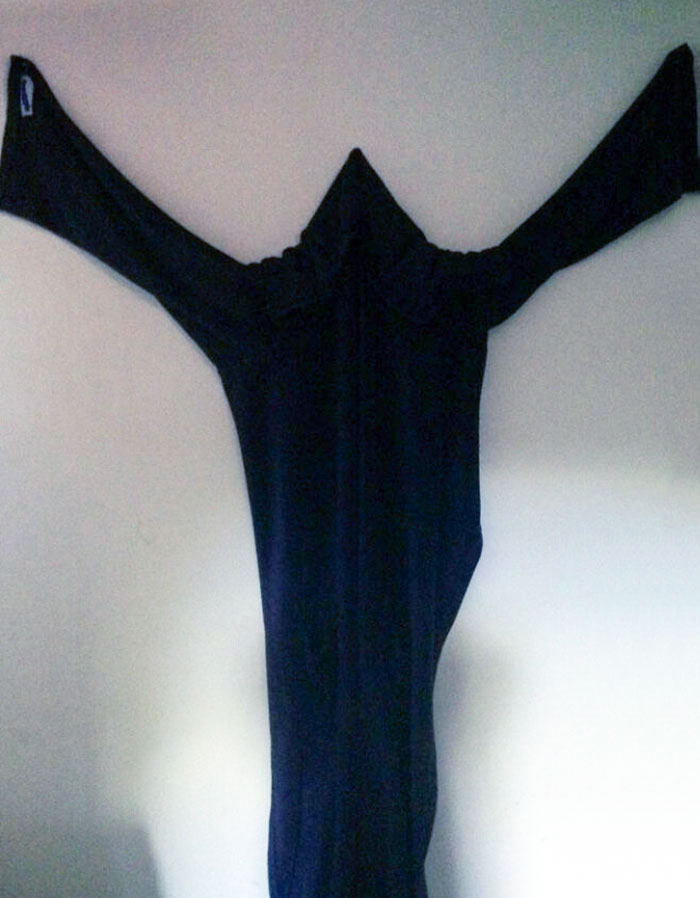 A hoodie hung on a wall resembles a ghost, showcasing a parent's sense of humor.