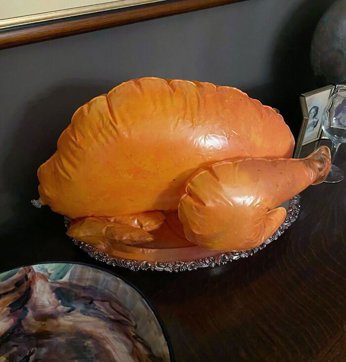 Inflatable turkey on a platter showcasing humorous parenting.
