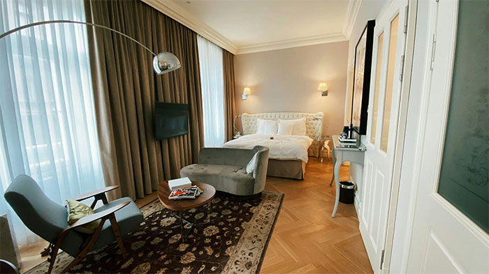 White and brown decor living room with chairs sofa and bed