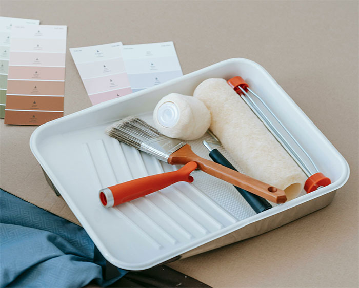 Paint roller and brush on plastic tray