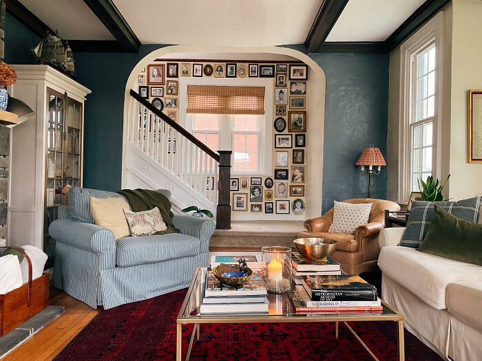 Living room featuring multiple family pictures arranged as stylish wall art ideas above the staircase in a cozy, inviting space.