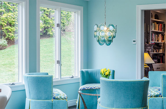 Light blue room with blue chairs and table showcasing a happy color to transform your home and bring joy