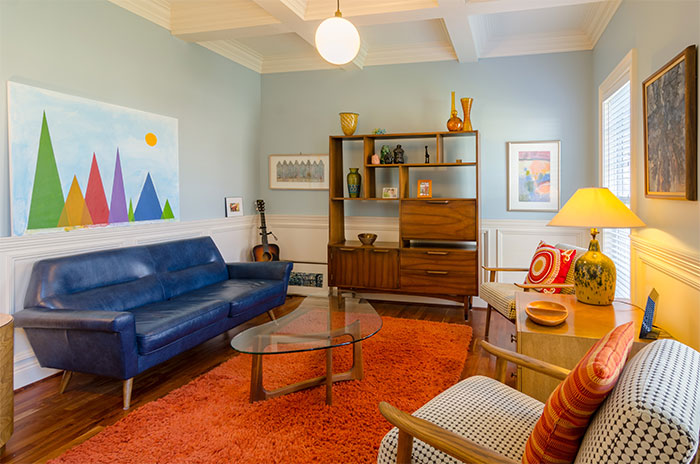 Light blue room with colorful furniture and decor showcasing a happy color that can transform your home and bring joy.