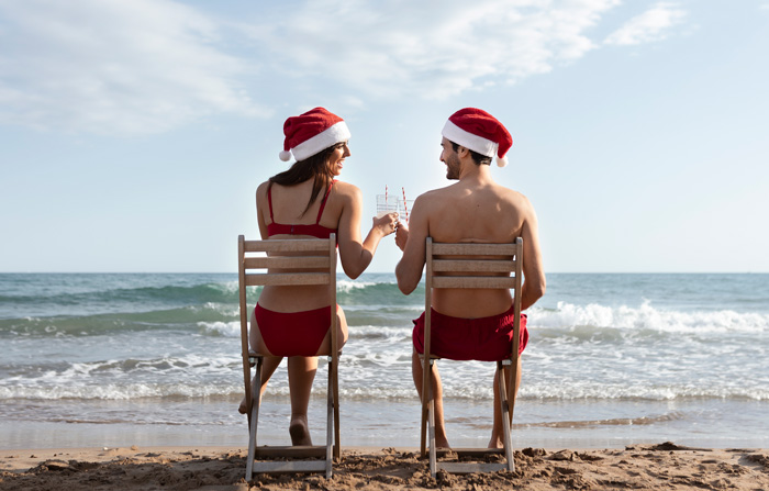 A couple sitting on the chairs on the beach 