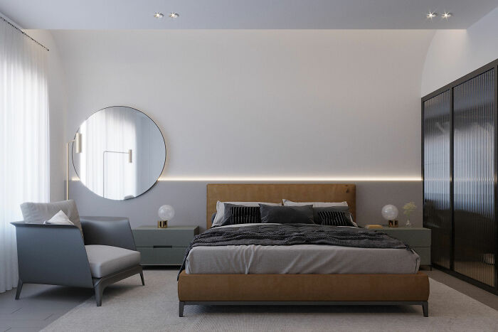 Gray bedroom featuring brown bed, sofa, cupboard, and round mirror showcasing expert-approved home design ideas.