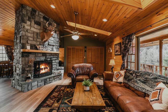 Rustic living room with fireplace, leather furniture, and wood accents showcasing expert-approved interior design ideas.