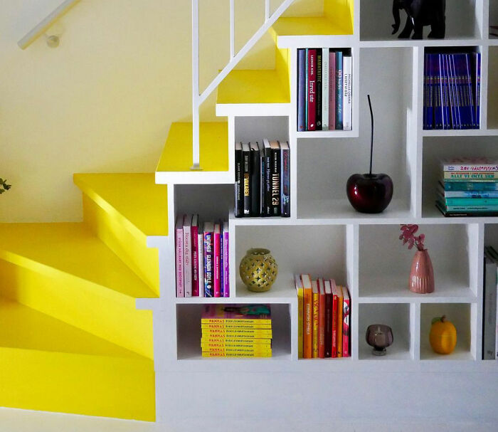 Room with bright yellow stairs and a modern bookshelf showcasing expert-approved interior design ideas for stylish home decor.