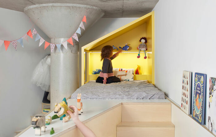 Child playing with toys in a bright, modern kids room showcasing expert-approved interior design ideas for home spaces.