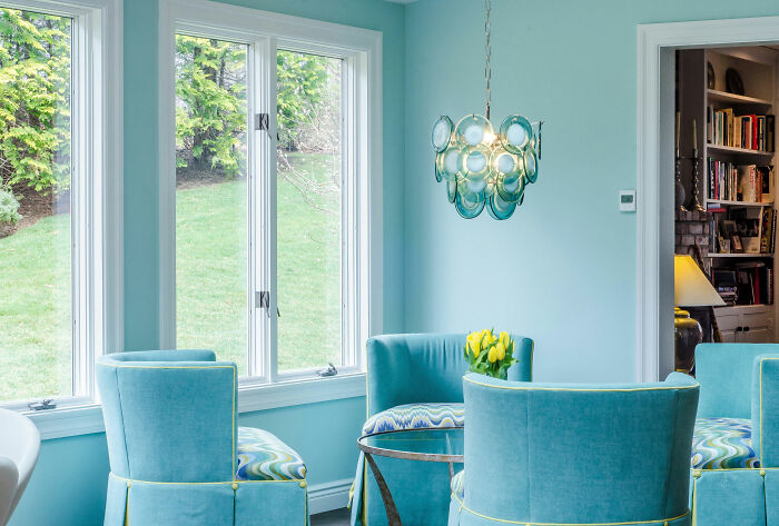 Blue room featuring blue chairs and table showcasing expert-approved interior design ideas for stylish home designs.