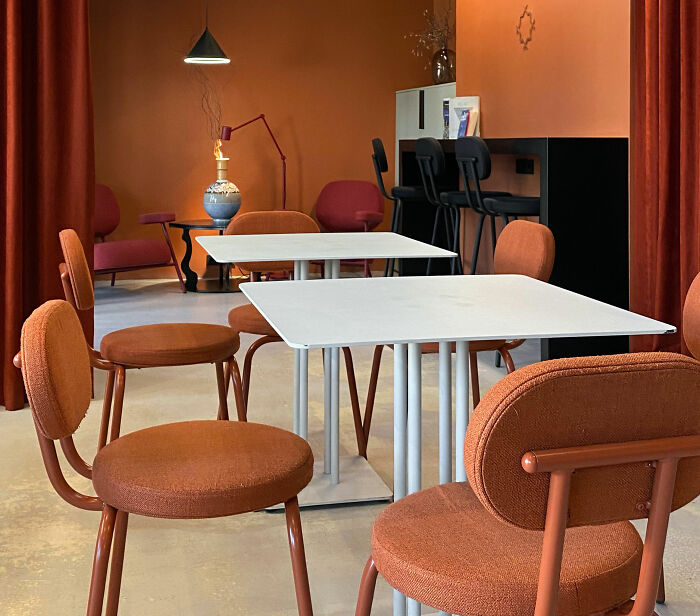 Brown room with white tables and brown chairs showcasing expert-approved interior design ideas for stylish home designs.