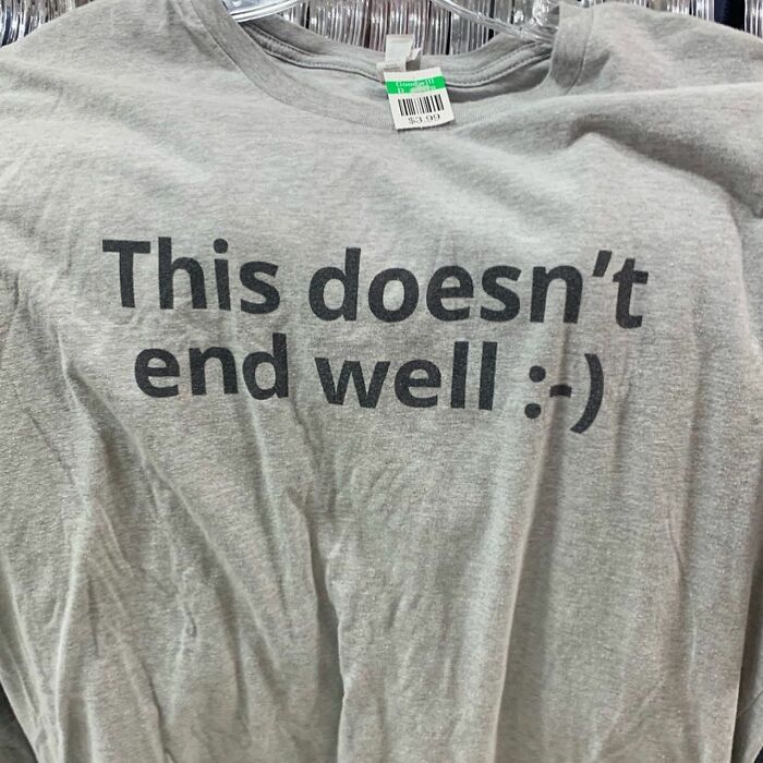 Gray thrift store shirt with text this doesn’t end well and a smiley face on a hanger with price tag visible