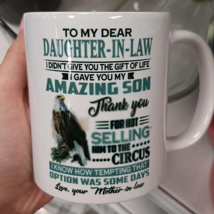 White mug with a humorous daughter-in-law message featuring an eagle, a weird item donated to thrift stores.