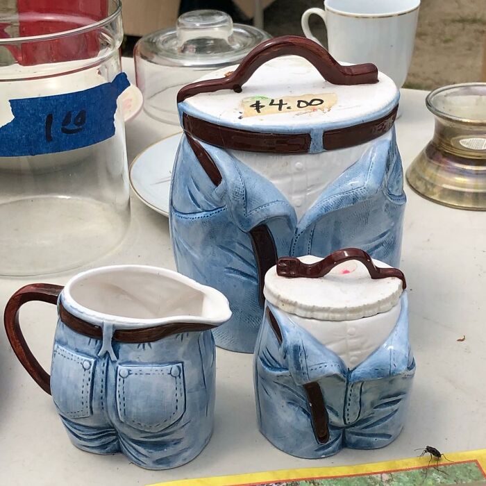 Ceramic pitchers and containers shaped like the lower half of blue jeans, a weird thrift store donation item.