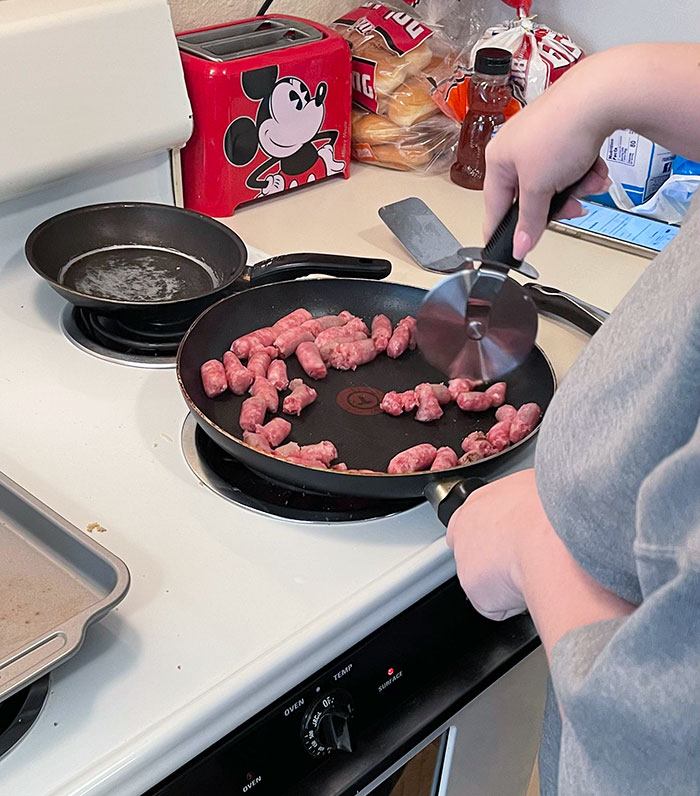 My Wife Cutting The Sausages For The Biscuits. That's Why The Other Pan Looks Like This