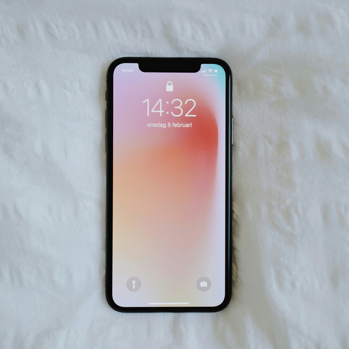 Smartphone with pink wallpaper 